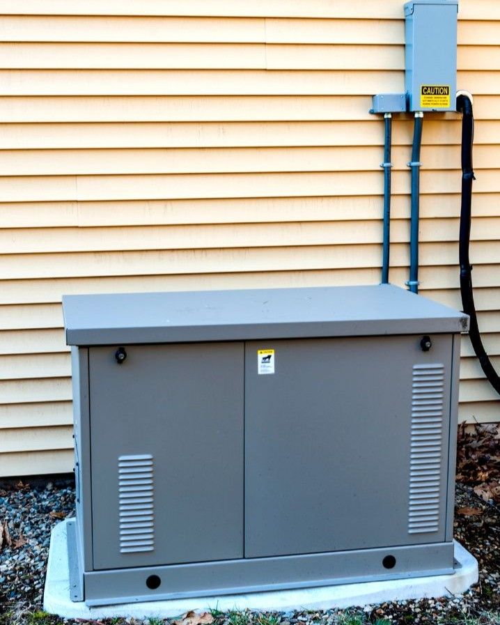 Whole-home standby generator installed beside a house
