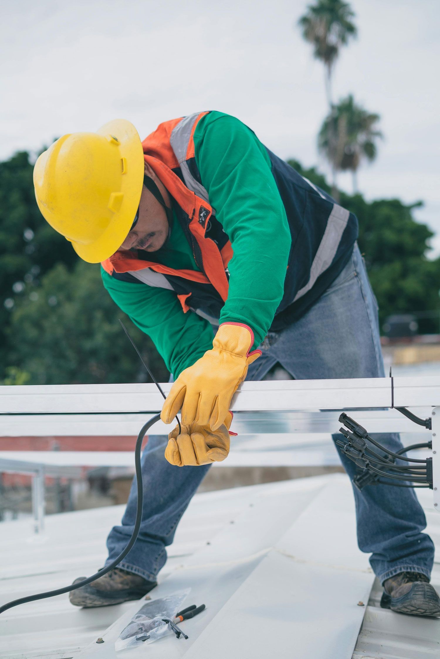 Electrician performing rooftop electrical work